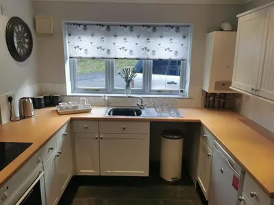 a kitchen with a sink and a window at Twyngaer, a spacious 3 bedroom bungalow sleeps 5 in Knighton