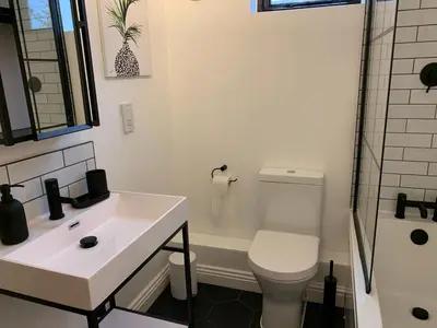 a bathroom with a sink and a toilet and a shower at St Milburga Chapel in Stoke Saint Milborough