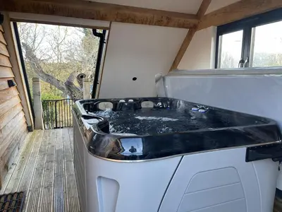 a large bath tub in a tiny house at Upper Gelli Luxury Holiday Lodge, Converted Dairy & Cosy Shepherds Huts in Welshpool