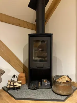a fireplace with a tv in a living room at Upper Gelli Luxury Holiday Lodge, Converted Dairy & Cosy Shepherds Huts in Welshpool