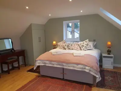 a bedroom with a large bed and a window at Delightful Country Cottage in a lovely rural area in Ludlow