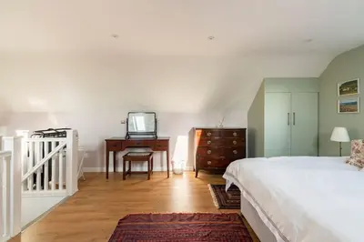 a bedroom with a bed and a desk with a television at Delightful Country Cottage in a lovely rural area in Ludlow