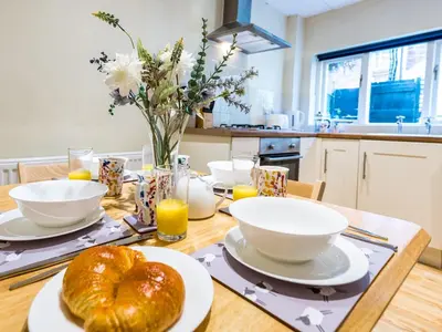 a table with bowls and plates of food on it at Cosy 2 bedroom Victorian Cottage - Pass the Keys in Ludlow