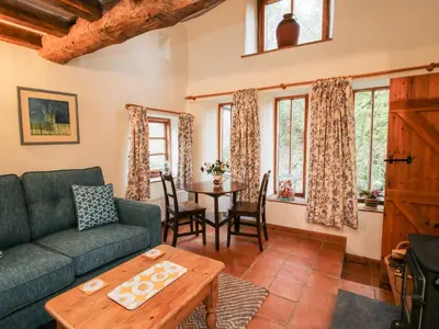 a living room with a couch and a table at Walkmill Barn in Bishops Castle