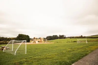 a field with two soccer goals in the grass at Bluebell in Rhayader