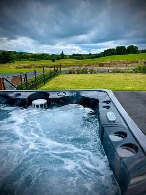 a jacuzzi tub with a table in the middle at Bluebell in Rhayader