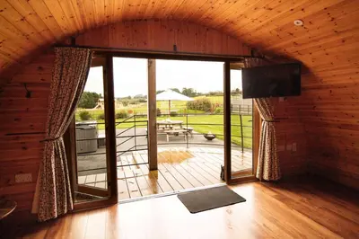 a large room with a large window and a patio at Bluebell in Rhayader
