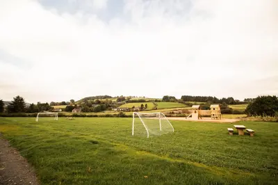 a field with two soccer goals in the grass at Buttercup in Rhayader