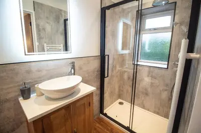 a bathroom with a sink and a shower at Ger Yr Afon in Saint Harmon