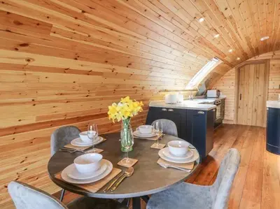 a dining room with a table and chairs in a cabin at Primrose in Rhayader