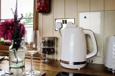 a kitchen counter with a blender and a wine glass at Rose in Rhayader