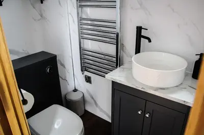 a bathroom with a sink and a toilet at Tulip in Rhayader