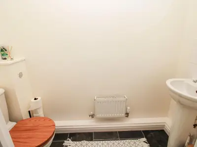 a bathroom with a toilet and a sink at 30 Poplar Close in Shrewsbury