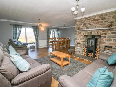 a living room with a couch and a fireplace at Pen Y Banc in Builth Wells