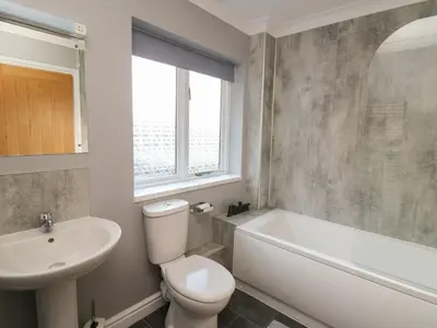 a bathroom with a toilet and a sink and a bath tub at Pen Y Banc in Builth Wells