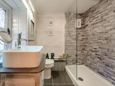 a bathroom with a sink and a toilet and a shower at Tegfan in Henfynyw Upper