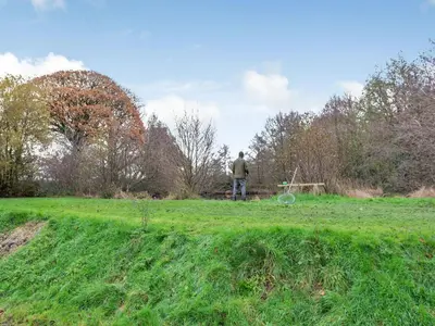 a man standing in a grassy field at Craigfryn in Llanerch-Aeron