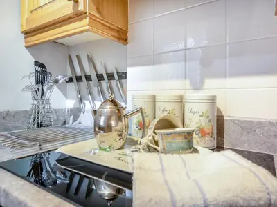 a kitchen with a counter top with dishes on it at Craigfryn in Llanerch-Aeron