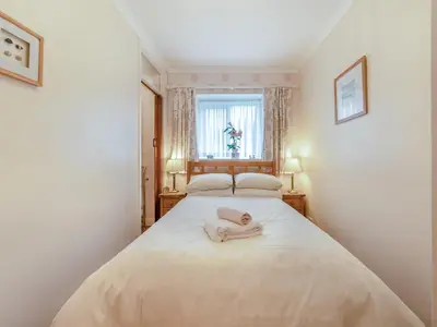a bedroom with a bed with a towel on it at Craigfryn in Llanerch-Aeron