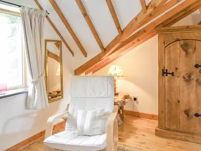 a white chair in a room with a window at Hafan Prysor in Trawsfynydd