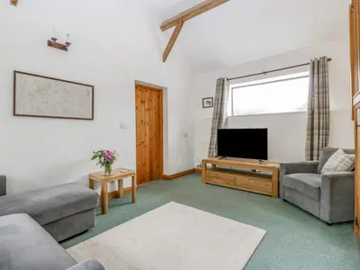a living room with a couch and a tv at Fieldfare in Leominster