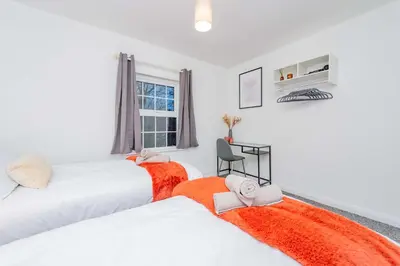 a bedroom with two beds and a window at Hereford Road Shrewsbury Cottage in Shrewsbury
