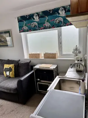 a living room with a couch and a window at Taylor Way - Superb Apartment with Living Room and Private Gated Parking in Aberystwyth