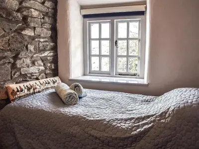 a bedroom with a bed and a window at Summerhill Tanyrhos in Blaenau-Ffestiniog