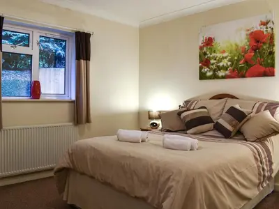 a bedroom with a large bed with two pillows at Gwynfan Bungalow in Llandrindod Wells