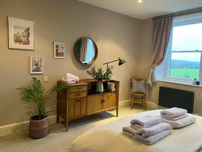 a bedroom with a bed with towels on it at Kennet House in Ludlow