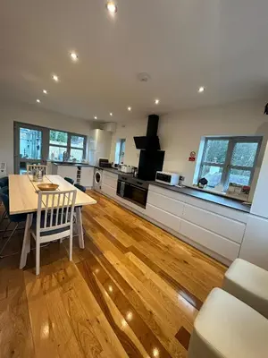 a kitchen with a table and a dining room at BROOK HOUSE 4a in Llangollen