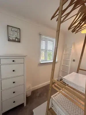 a bedroom with a bunk bed and a dresser at BROOK HOUSE 4a in Llangollen