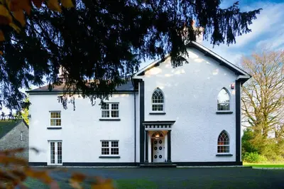 a large white house with a large door at Ty Bledrws - family retreat near the Cardigan Bay coast in Llangybi