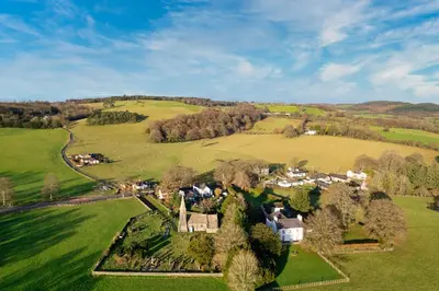 an aerial view of a village in a green field at Ty Bledrws - family retreat near the Cardigan Bay coast in Llangybi