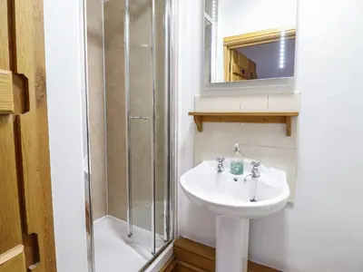 a bathroom with a sink and a shower at Ynys in Dyffryn