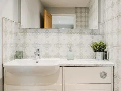 a bathroom with a sink and a mirror at Swallow Lodge - Uk42540 in Winforton