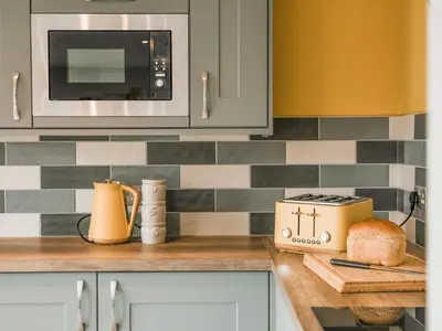 a kitchen with a counter top with a toaster and a microwave at Swallow Lodge - Uk42540 in Winforton