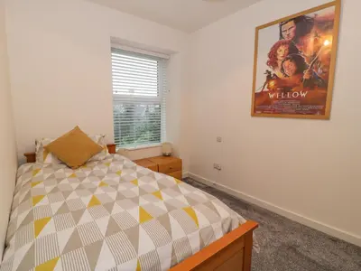 a bedroom with a movie poster on the wall at Bronwen House in Llanbedr
