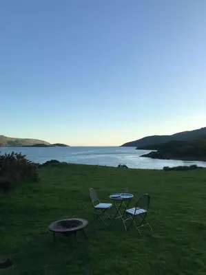 a table and two chairs and a table and a table and chairs at Snowdonia Shepherds Hut + Hot Tub in Barmouth