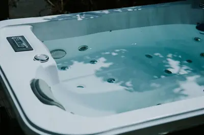 a white bathtub with the reflection of a dolphin in it at Snowdonia Shepherds Hut + Hot Tub in Barmouth