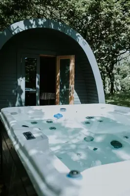 a bathroom with a sink in front of a mirror at Snowdonia Mawddach Cabin and hot tub Glamping in Barmouth