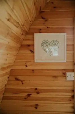 a picture of a heart on a wooden wall at Snowdonia Mawddach Cabin and hot tub Glamping in Barmouth
