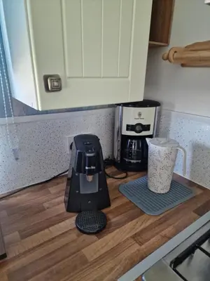 a kitchen counter with a blender on a wooden floor at Chalet 88 in Aberystwyth