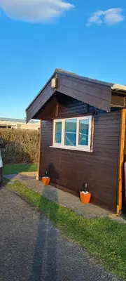 a small house with a window on the side of it at Chalet 88 in Aberystwyth