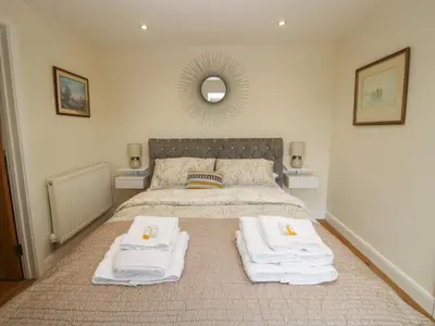 a bedroom with a bed with towels on it at Stable Cottage in Bishops Castle
