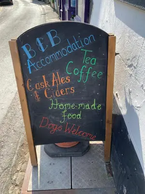 a chalkboard sign on the side of a street at The Slaters Arms Corris in Machynlleth