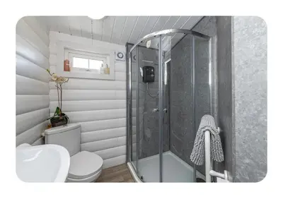 a bathroom with a shower with a toilet and a sink at Snowdonia Escapes # TRANQUIL CABIN with Views, Wi-Fi, Dog Friendly & Parking in Trawsfynydd