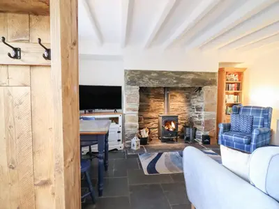 a living room with a fireplace and a tv at Ael Y Bryn in Blaenau-Ffestiniog