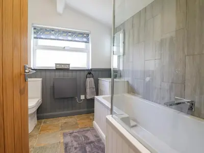 a bathroom with a tub and a toilet and a sink at Ael Y Bryn in Blaenau-Ffestiniog