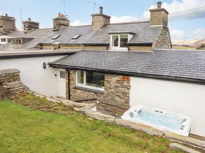a house with a hot tub on the side of it at Ael Y Bryn in Blaenau-Ffestiniog